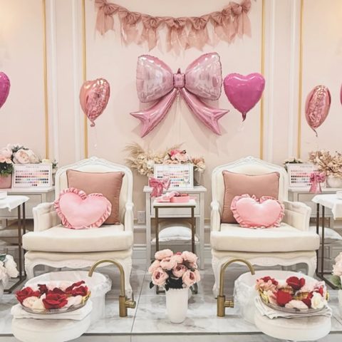Pedicure chairs dressed for Valentine's with pink bows, hearts and roses